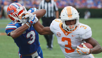 GAINESVILLE, FL - SEPTEMBER 16: Ty Chandler #3 of the Tennessee Volunteers runs away from Marco Wilson #3 of the Florida Gators during the second half of their game at Ben Hill Griffin Stadium on September 16, 2017 in Gainesville, Florida. (Photo by Scott Halleran/Getty Images)