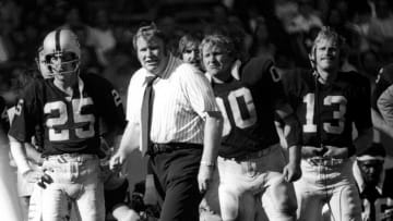 CLEVELAND, OHIO - OCTOBER 06: John Madden, Oakland Raiders coach, during an NFL football game against the Cleveland Browns at Cleveland Municipal Stadium on October 6, 1994. The Raiders defeated the Browns 40-24. Oakland players flanking Madden are #25 Fred Belitnikoff (Wide Receiver), #13 Larry Lawrence (backup Quarterback, and #00 Jim Otto Center. (Photo by Ross Lewis/Getty Images)