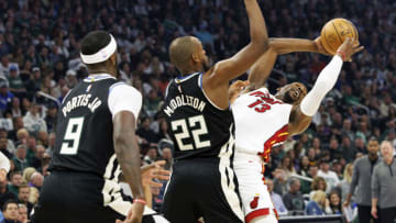 Apr 19, 2023; Milwaukee, Wisconsin, USA; Milwaukee Bucks forward Khris Middleton (22) defends Miami Heat center Bam Adebayo (13) during the first quarter during game two of the 2023 NBA Playoffs at Fiserv Forum. Mandatory Credit: Jeff Hanisch-USA TODAY Sports