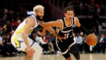 ATLANTA, GEORGIA - DECEMBER 02: Trae Young #11 of the Atlanta Hawks drives against Ky Bowman #12 of the Golden State Warriors in the second half at State Farm Arena on December 02, 2019 in Atlanta, Georgia. NOTE TO USER: User expressly acknowledges and agrees that, by downloading and/or using this photograph, user is consenting to the terms and conditions of the Getty Images License Agreement. (Photo by Kevin C. Cox/Getty Images)