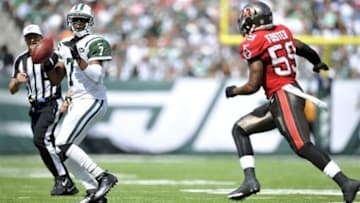 Sep 8, 2013; East Rutherford, NJ, USA; New York Jets quarterback Geno Smith (7) scrambles against the Tampa Bay Buccaneers during the first half at MetLife Stadium. The Jets won 18-17. Mandatory Credit: Joe Camporeale-USA TODAY Sports