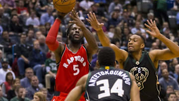 Nov 25, 2016; Milwaukee, WI, USA; Toronto Raptors forward DeMarre Carroll (5) shoots between Milwaukee Bucks forward Giannis Antetokounmpo (34) and forward Jabari Parker (12) during the first quarter at BMO Harris Bradley Center. Mandatory Credit: Jeff Hanisch-USA TODAY Sports