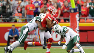 KANSAS CITY, MO - SEPTEMBER 25: Tight end Ross Travis #88 of the Kansas City Chiefs is tackled by Marcus Gilchrist #21 and outside linebacker Darron Lee #50 of the New York Jets at Arrowhead Stadium during the first quarter of the game on September 25, 2016 in Kansas City, Missouri. (Photo by Jamie Squire/Getty Images)