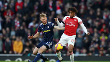 LONDON, ENGLAND - JANUARY 01: Alex Iwobi of Arsenal battles for possession with Tim Ream of Fulham during the Premier League match between Arsenal FC and Fulham FC at Emirates Stadium on January 1, 2019 in London, United Kingdom. (Photo by Catherine Ivill/Getty Images)