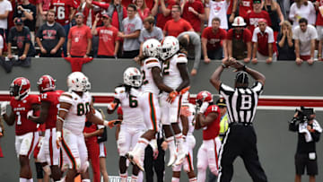 RALEIGH, NC - NOVEMBER 19: Malek Young #12 of the Miami Hurricanes celebrates his interception with teammate Sheldrick Redwine #22 during their game against the North Carolina State Wolfpack at Carter-Finley Stadium on November 19, 2016 in Raleigh, North Carolina. Miami won 27-13. (Photo by Lance King/Getty Images)