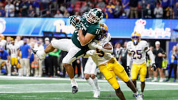 Michigan State tight end Connor Heyward catches for a touchdown against Pittsburgh defensive lineman Deslin Alexandre during the second half of the 31-21 win over Pittsburgh in the Peach Bowl at the Mercedes-Benz Stadium in Atlanta on Thursday, Dec. 30, 2021.
