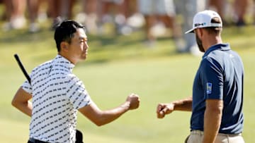AUSTIN, TEXAS - MARCH 26: Kevin Na of the United States fist bumps Dustin Johnson of the United States after winning their match during the third round of the World Golf Championships-Dell Technologies Match Play at Austin Country Club on March 26, 2021 in Austin, Texas. (Photo by Michael Reaves/Getty Images)
