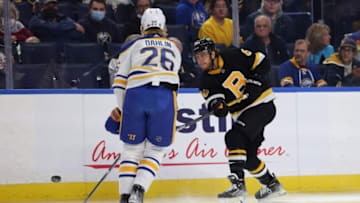 Oct 22, 2021; Buffalo, New York, USA; Buffalo Sabres defenseman Rasmus Dahlin (26) tries to block a shot by Boston Bruins right wing David Pastrnak (88) during the first period at KeyBank Center. Mandatory Credit: Timothy T. Ludwig-USA TODAY Sports