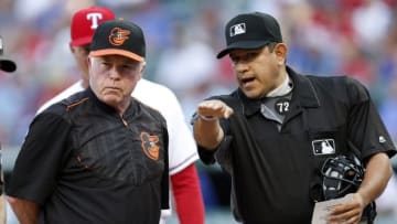 Jun 20, 2016; Arlington, TX, USA; Baltimore Orioles manager Buck Showalter and umpire Alfonso Marquez (72) talk before a baseball game against the Texas Rangers at Globe Life Park in Arlington. Mandatory Credit: Jim Cowsert-USA TODAY Sports