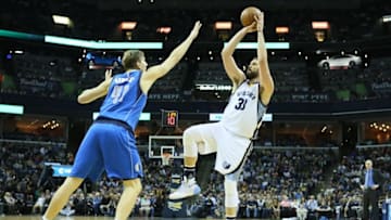 Feb 6, 2016; Memphis, TN, USA; Memphis Grizzlies center Marc Gasol (33) shoots in the second quarter as Dallas Mavericks forward Dirk Nowitzki (41) defends at FedExForum. Mandatory Credit: Nelson Chenault-USA TODAY Sports