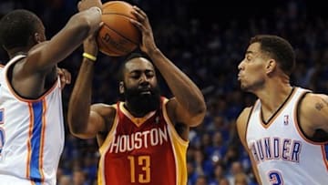 May 1, 2013; Oklahoma City, OK, USA; Houston Rockets guard James Harden (13) handles the ball against Oklahoma City Thunder guard Reggie Jackson (15) and Thunder guard Thabo Sefolosha (2) during the first half in game five of the first round of the 2013 NBA Playoffs at Chesapeake Energy Arena. Mandatory Credit: Mark D. Smith-USA TODAY Sports