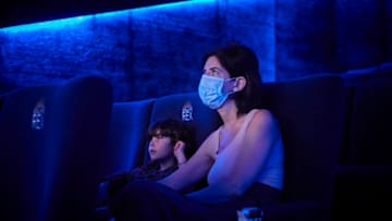 PARIS, FRANCE - AUGUST 03: A mother and son watch one of the last showings at the Grand Rex Cinema, before it closes its doors until August 26, for the first time in it's history since it opened in 1932 on August 03, 2020 in Paris, France. The Grand Rex, Paris's landmark art deco 2800-seat theatre that stayed open during World War II, is closing temporarily amidst the ongoing pandemic and shortage of blockbuster films to screen. (Photo by Kiran Ridley/Getty Images)