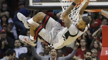 Jan 24, 2016; Houston, TX, USA; Houston Rockets forward Trevor Ariza (1) hangs on the rim after he dunks against the Dallas Mavericks in the second half at Toyota Center. Rockets won 115 to 104. Mandatory Credit: Thomas B. Shea-USA TODAY Sports