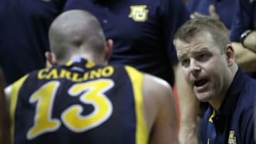 Nov 27, 2014; Kissimmee, FL, USA; Marquette Golden Eagles head coach Steve Wojciechowski huddles up and talks with guard Matt Carlino (13) and teammates against the Georgia Tech Yellow Jackets during the second half at HP Field House. Marquette Golden Eagles defeated the Georgia Tech Yellow Jackets 72-70. Mandatory Credit: Kim Klement-USA TODAY Sports