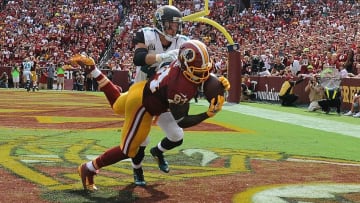Sep 14, 2014; Landover, MD, USA; Washington Redskins tight end Niles Paul (84) chatches a touchdown as Jacksonville Jaguars strong safety Chris Prosinski (42) defends during the second half at FedEx Field. Mandatory Credit: Brad Mills-USA TODAY Sports