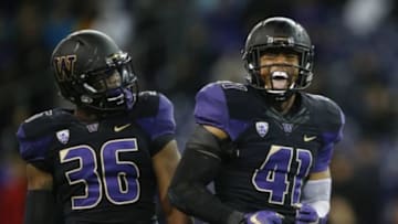 Oct 31, 2015; Seattle, WA, USA; Washington Huskies linebacker Azeem Victor (36) watches as linebacker Travis Feeney (41) celebrates a sack of Arizona Wildcats quarterback Anu Solomon (not pictured) during the second quarter at Husky Stadium. Mandatory Credit: Jennifer Buchanan-USA TODAY Sports