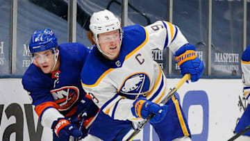 Feb 22, 2021; Uniondale, New York, USA; Buffalo Sabres center Jack Eichel (9) and New York Islanders defenseman Ryan Pulock (6) battle for position during the third period at Nassau Veterans Memorial Coliseum. Mandatory Credit: Andy Marlin-USA TODAY Sports