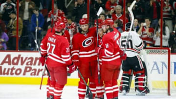 Jan 26, 2016; Raleigh, NC, USA; Carolina Hurricanes forward Jay McClement (18) is congratulated by teammates defensemen Justin Faulk (27), forward Elias Lindholm (16), forward Jeff Skinner (53) and defensemen Ron Hainsey (65) after his first period goal against the Chicago Blackhawks at PNC Arena. Mandatory Credit: James Guillory-USA TODAY Sports