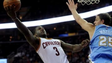 Nov 17, 2014; Cleveland, OH, USA; Cleveland Cavaliers guard Dion Waiters (3) shoots as Denver Nuggets center Timofey Mozgov (25) defends during the third quarter at Quicken Loans Arena. The Nuggets beat the Cavaliers 106-97. Mandatory Credit: Ken Blaze-USA TODAY Sports