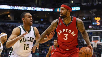 Mar 15, 2016; Milwaukee, WI, USA; Milwaukee Bucks forward Jabari Parker (12) guards Toronto Raptors forward James Johnson (3) in the first quarter at BMO Harris Bradley Center. Mandatory Credit: Benny Sieu-USA TODAY Sports