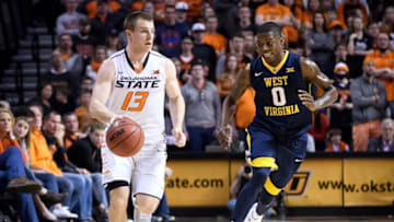 Dec 30, 2016; Stillwater, OK, USA; Oklahoma State Cowboys guard Phil Forte III (13) dribbles past West Virginia Mountaineers guard Teyvon Myers (0) during the second half at Gallagher-Iba Arena. WVU won 92-75. Mandatory Credit: Rob Ferguson-USA TODAY Sports