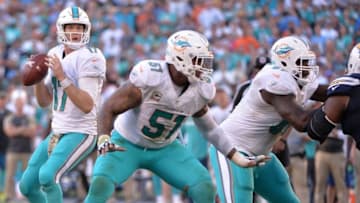 Nov 13, 2016; San Diego, CA, USA; Miami Dolphins quarterback Ryan Tannehill (17) looks to pass while protected by center Mike Pouncey (51) and offensive guard Laremy Tunsil (67) during the second half against the San Diego Chargers at Qualcomm Stadium. Miami won 31-24. Mandatory Credit: Orlando Ramirez-USA TODAY Sports