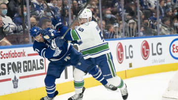 Mar 5, 2022; Toronto, Ontario, CAN; Toronto Maple Leafs center John Tavares (91) battles for the puck with Vancouver Canucks center Bo Horvat (53) during the first period at Scotiabank Arena. Mandatory Credit: Nick Turchiaro-USA TODAY Sports