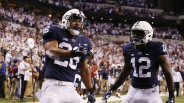 Dec 3, 2016; Indianapolis, IN, USA; Penn State Nittany Lions running back Saquon Barkley (26) celebrates with teammates after catching a touchdown pass against the Wisconsin Badgers in the second half during the Big Ten Championship college football game at Lucas Oil Stadium. Mandatory Credit: Brian Spurlock-USA TODAY Sports