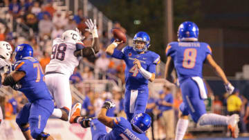 BOISE, ID - SEPTEMBER 8: Quarterback Brett Rypien #4 of the Boise State Broncos passes under pressure from defensive lineman Lwal Uguak #98 of the Connecticut Huskies during first half action on September 8, 2018 at Albertsons Stadium in Boise, Idaho. (Photo by Loren Orr/Getty Images)