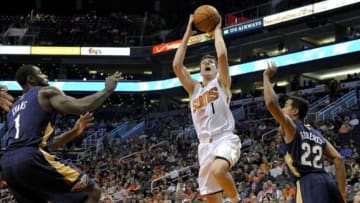 Nov 10, 2013; Phoenix, AZ, USA; Phoenix Suns point guard Goran Dragic (1) shoots the ball under pressure from New Orleans Pelicans point guard Tyreke Evans (1) and point guard Brian Roberts (22) during the second quarter at US Airways Center. Mandatory Credit: Casey Sapio-USA TODAY Sports