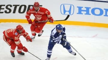 Jan 1, 2014; Ann Arbor, MI, USA; Toronto Maple Leafs right wing Joffrey Lupul (19) carries the puck in front of Detroit Red Wings defenseman Niklas Kronwall (55) and right wing Daniel Cleary (71) during the 2014 Winter Classic hockey game at Michigan Stadium. Mandatory Credit: Tim Fuller-USA TODAY Sports