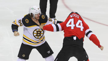 Jan 16, 2021; Newark, New Jersey, USA; Boston Bruins defenseman Kevan Miller (86) and New Jersey Devils left wing Miles Wood (44) fight during the first period at Prudential Center. Mandatory Credit: Ed Mulholland-USA TODAY Sports
