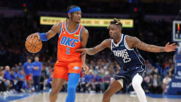 OKC Thunder guard Shai Gilgeous-Alexander (2) is defended by Mavericks forward Reggie Bullock (25) as he dribbles the ball down the court : Alonzo Adams-USA TODAY Sports