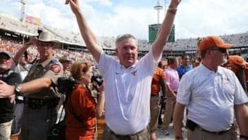 Oct 12, 2013; Dallas, TX, USA; Texas Longhorns head coach Mack Brown celebrates with his team after a victory against the Oklahoma Sooners for the Red River Rivalry. The Texas Longhorns beat the Oklahoma Sooners 36-20. Mandatory Credit: Matthew Emmons-USA TODAY Sports