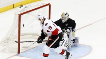 Apr 13, 2014; Pittsburgh, PA, USA; Ottawa Senators center Jason Spezza (19) scores against Pittsburgh Penguins goalie Jeff Zatkoff (37) during the shootout at the CONSOL Energy Center. The Senators won 3-2 in a shootout. Mandatory Credit: Charles LeClaire-USA TODAY Sports