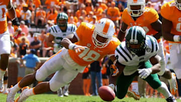 Sep 17, 2016; Knoxville, TN, USA; Tennessee Volunteers defensive back Nigel Warrior (18) and Ohio Bobcats running back Papi White (4) dive for a fumble during the second half at Neyland Stadium. Tennessee won 28 to 19. Mandatory Credit: Randy Sartin-USA TODAY Sports