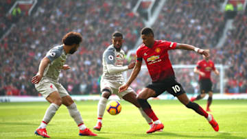 MANCHESTER, ENGLAND - FEBRUARY 24: Marcus Rashford of Manchester United runs with the ball under pressure from Mohamed Salah and Georginio Wijnaldum of Liverpool during the Premier League match between Manchester United and Liverpool FC at Old Trafford on February 24, 2019 in Manchester, United Kingdom. (Photo by Clive Brunskill/Getty Images)
