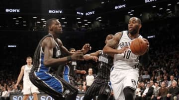 Apr 13, 2014; Brooklyn, NY, USA; Brooklyn Nets center Marcus Thornton (10) looks to pass the ball against Orlando Magic center Dewayne Dedmon (3) in the fourth quarter at Barclays Center. Nets win 97-88. Mandatory Credit: Nicole Sweet-USA TODAY Sports