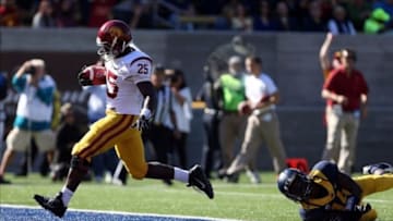 Nov 9, 2013; Berkeley, CA, USA; USC Trojans running back Silas Redd (25) runs in for a touchdown ahead of California Golden Bears cornerback Cameron Walker (14) during the first quarter at Memorial Stadium. Mandatory Credit: Kelley L Cox-USA TODAY Sports
