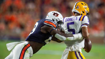Auburn footballLSU Tigers quarterback Jayden Daniels (5) fumbles the ball out of bounds as he is tackled by Auburn Tigers defensive lineman Derick Hall (29) as Auburn Tigers take on LSU Tigers at Jordan-Hare Stadium in Auburn, Ala., on Saturday, Oct. 1, 2022. Auburn Tigers lead LSU Tigers 17-14 at halftime.