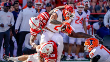 Oct 29, 2022; Lincoln, Nebraska, USA; Illinois Fighting Illini running back Chase Brown (2) is stopped by Nebraska Cornhuskers linebacker Luke Reimer (28) and defensive end Jimari Butler (10) during the second quarter at Memorial Stadium. Mandatory Credit: Dylan Widger-USA TODAY Sports