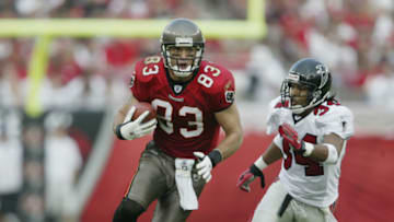 TAMPA, FL - DECEMBER 8: Joe Jurevicius #83 of the Tampa Bay Buccaneers runs with the ball while pursued by Ray Buchanan #34 of the Atlanta Falcons during the NFL game on December 8, 2002 at Raymond James Stadium in Tampa, Florida. The Buccaneers defeated the Falcons 34-10. (Photo by Andy Lyons/Getty Images)