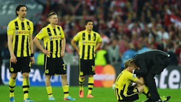 LONDON, ENGLAND - MAY 25: (L-R) Neven Subotic, Lukasz Piszczek and Nuri Sahin of Borussia Dortmund look on as Marco Reus is consoled by Head Coach Jurgen Klopp of Borussia Dortmund in defeat after the UEFA Champions League final match between Borussia Dortmund and FC Bayern Muenchen at Wembley Stadium on May 25, 2013 in London, United Kingdom. (Photo by Laurence Griffiths/Getty Images)
