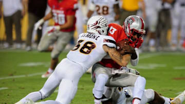 Sep 18, 2015; Tempe, AZ, USA; New Mexico Lobos quarterback Lamar Jordan (13) is tackled by Arizona State Sun Devils defensive back Jordan Simone (38) during the second half at Sun Devil Stadium. Mandatory Credit: Matt Kartozian-USA TODAY Sports