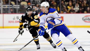 PITTSBURGH, PENNSYLVANIA - DECEMBER 17: John Hayden #15 of the Buffalo Sabres skates with the puck against Kris Letang #58 of the Pittsburgh Penguins during the second period of a game at PPG PAINTS Arena on December 17, 2021 in Pittsburgh, Pennsylvania. (Photo by Emilee Chinn/Getty Images)