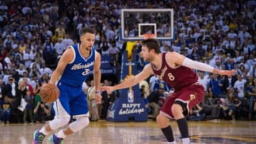 December 25, 2015; Oakland, CA, USA; Golden State Warriors guard Stephen Curry (30) dribbles the basketball against Cleveland Cavaliers guard Matthew Dellavedova (8) during the fourth quarter in a NBA basketball game on Christmas at Oracle Arena. The Warriors defeated the Cavaliers 89-83. Mandatory Credit: Kyle Terada-USA TODAY Sports