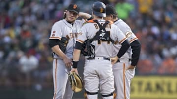 Jun 29, 2016; Oakland, CA, USA; San Francisco Giants pitching coach Dave Righetti (19), starting pitcher Jake Peavy (22) and catcher Trevor Brown (14) talk it over in the third inning against the Oakland Athletics at the Coliseum. Mandatory Credit: Neville E. Guard-USA TODAY Sports