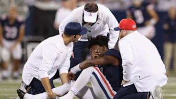 TUCSON, ARIZONA - OCTOBER 09: Quarterback Jordan McCloud #4 of the Arizona Wildcats reacts after a fumble and an injury as head coach Jed Fisch looks in during the second half of the NCAAF game against the UCLA Bruins at Arizona Stadium on October 09, 2021 in Tucson, Arizona. (Photo by Christian Petersen/Getty Images)
