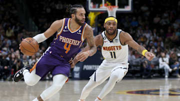 DENVER, COLORADO - OCTOBER 10: Duane Washington Jr. #4 of the Phoenix Suns drives against Bruce Brown #11 of the Denver Nuggets in the fourth quarter during a preseason game at Ball Arena on October 10, 2022 in Denver, Colorado. (Photo by Matthew Stockman/Getty Images)