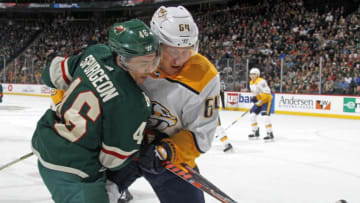 ST. PAUL, MN - MARCH 25: Jared Spurgeon #46 of the Minnesota Wild and Mikael Granlund #64 of the Nashville Predators battle for the puck during a game at Xcel Energy Center on March 25, 2019 in St. Paul, Minnesota.(Photo by Bruce Kluckhohn/NHLI via Getty Images)